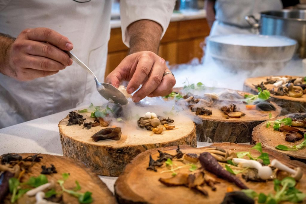 pexels-photo-1267320-1267320 Chef Preparing Vegetable Dish on Tree Slab