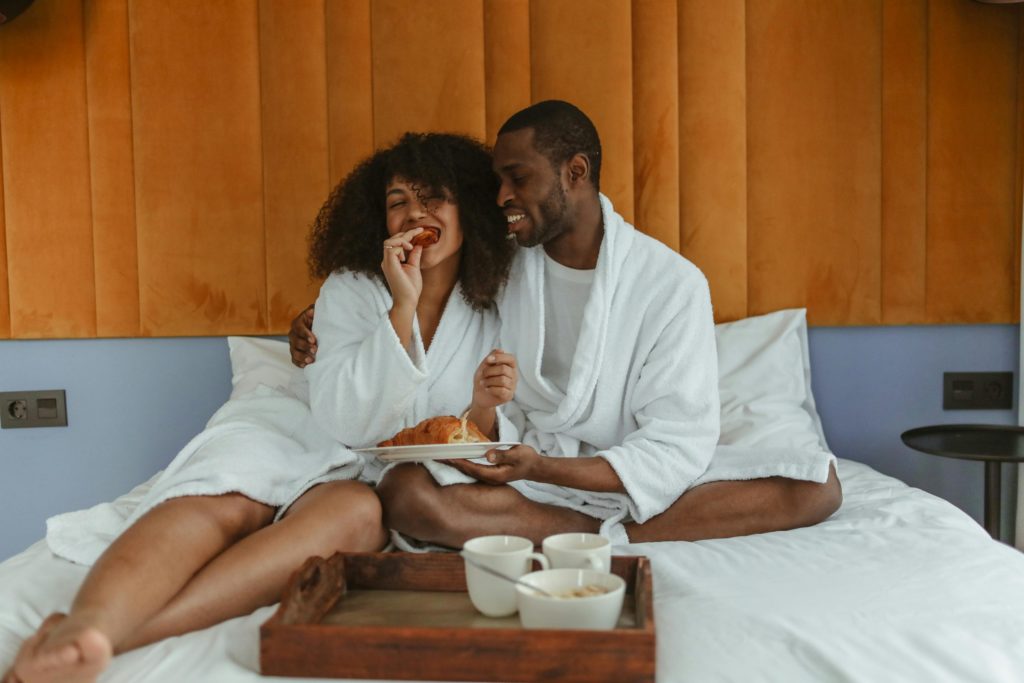 pexels-photo-6429547-6429547 Woman in White Robe Eating on the Bed